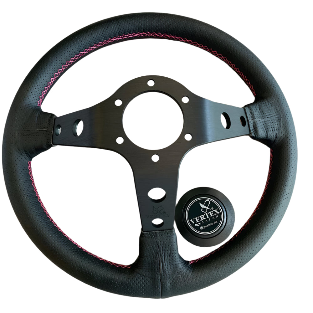 Black steering wheel with pink stitching, featuring the Vertex logo.