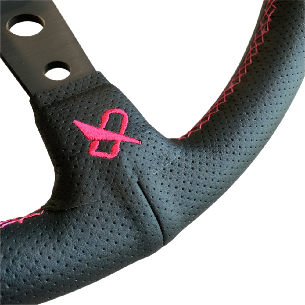 Black steering wheel cover with pink logo on a white background